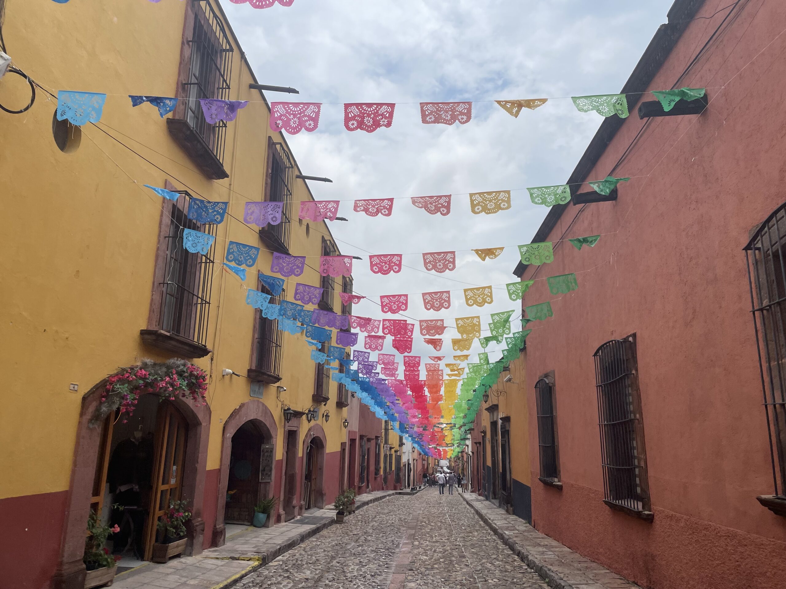 rainbow colored banners across a street in San Miguel de Allende