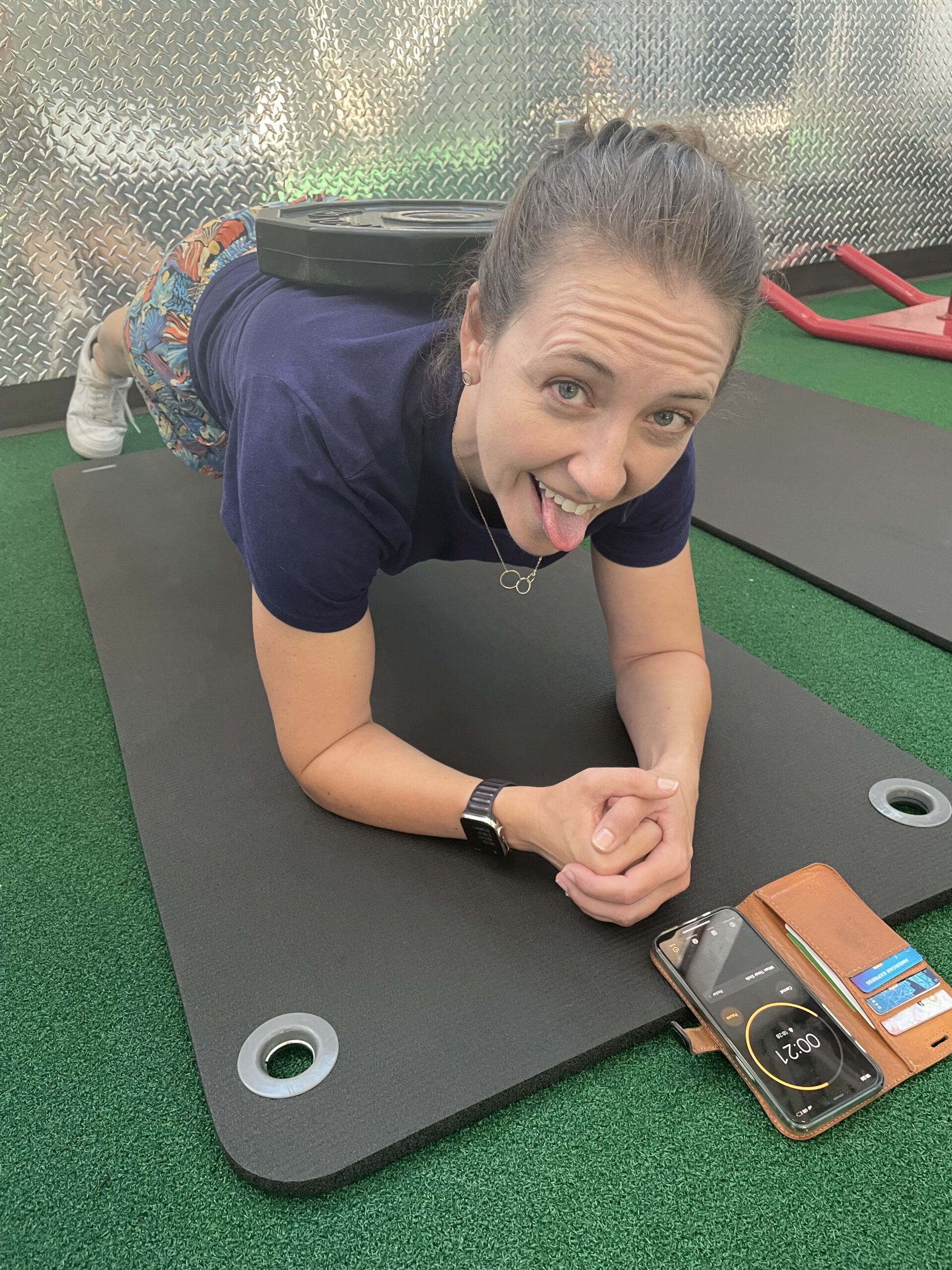 Amber in a plank position with a weight on her back