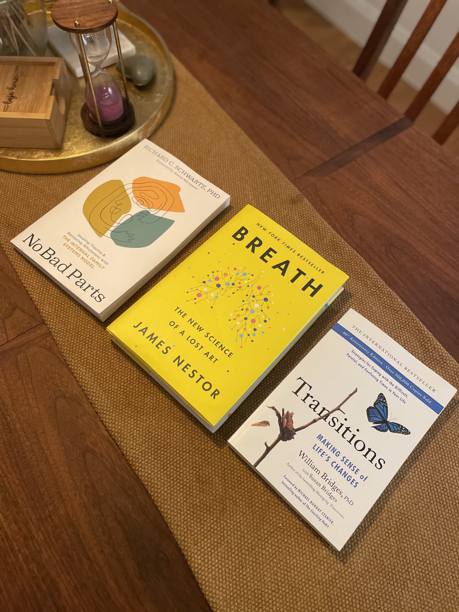 Three books on a table: No Bad Parts, Breath, and Transitions
